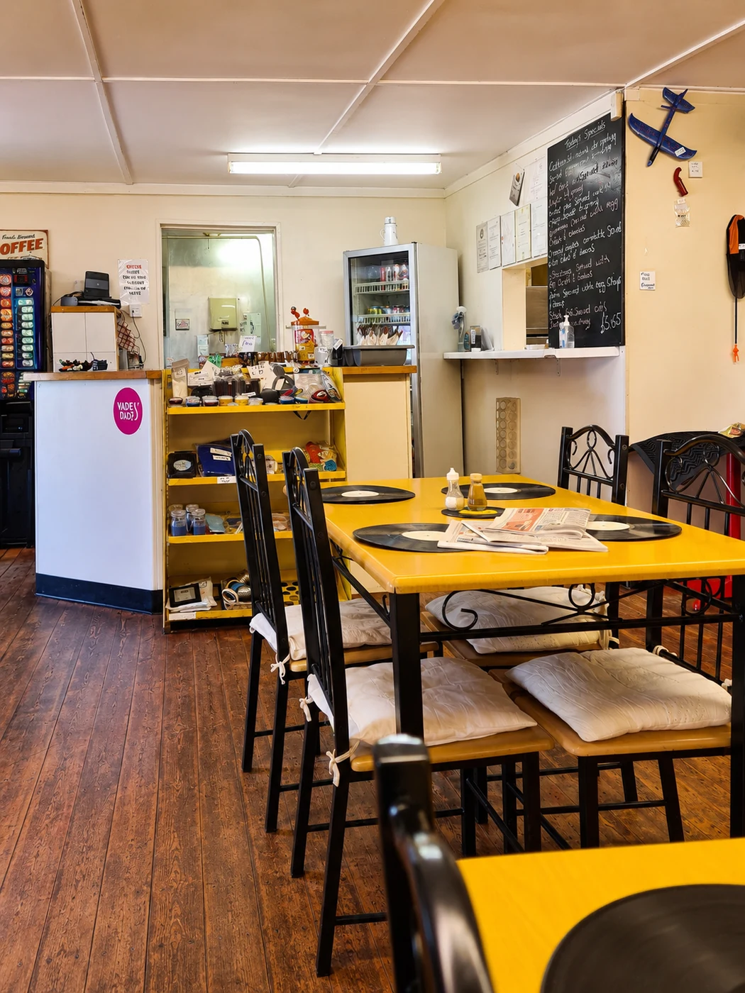 Inside Gem Cafe Coxhoe with yellow tables and café seating